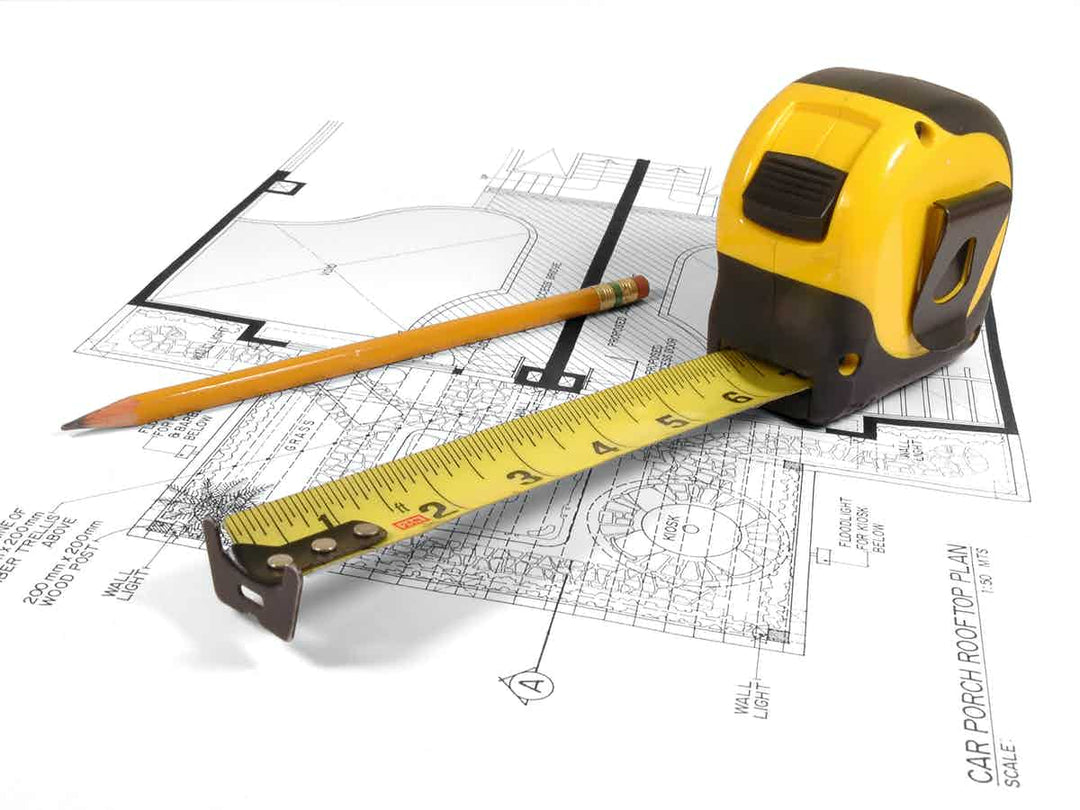 Tape measure on architect's drawing with pencil 